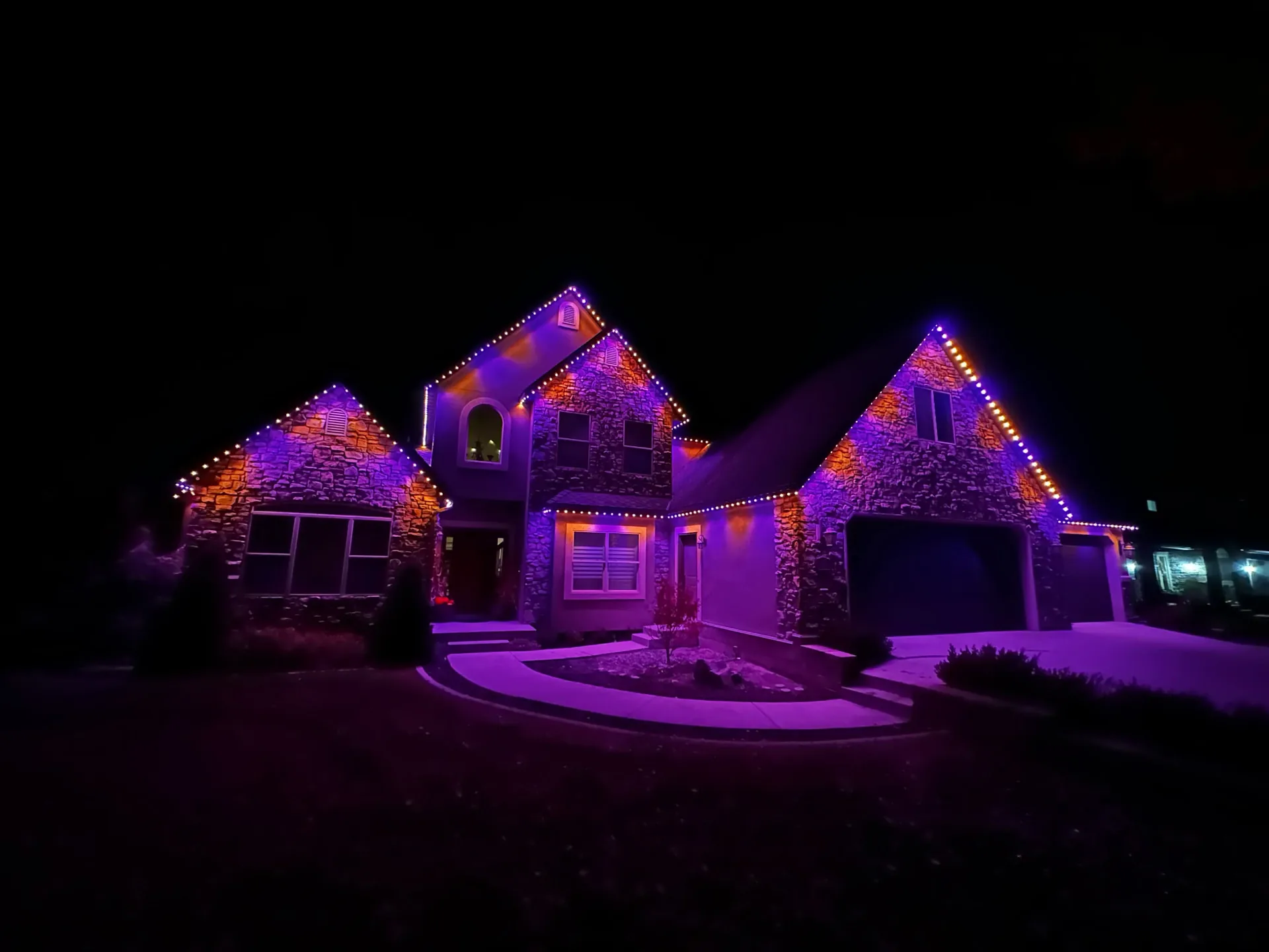 Stone home with purple and orange autumn lighting
